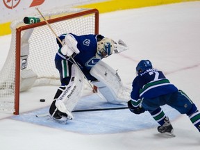 Canucks Dan Hamhuis and goalie Roberto Luongo watch as a Canucks pass bounces off Luongo’s skates and into their net Saturday in a game against the Montreal Canadiens. The Canucks lost 4-1. (THE CANADIAN PRESS FILES)