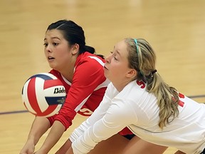 Simon Fraser University's Alison McKay (right) and Alanna Chan team up for a dig in SFU's dramatic 3-2 win over Central Washington University in GNAC play at the West Gym. (Ron Hole, SFU athletics)