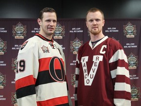 OTTAWA, ON.: NOVEMBER 28, 2013 --  Jason Spezza (L) of the Ottawa Senators and Henrik Sedin of the Vancouver Canucks unveil their respective classic jerseys, at Canadian Tire Centre, on November 28, 2013, in Ottawa, Ont. The Senators will wear their classic jersey during the NHL Heritage Classic game that will be played outdoors in Vancouver on March 2nd, 2014. (Jana Chytilova / Ottawa Citizen)