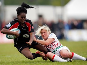 Arielle Dubissette-Borrice of Canada is tackled by Claire Allan of England during the IRB Women's Sevens World Series match between England and Canada at the National Rugby Centre Amsterdam Sportpark de Eendracht on May 18, 2013 in Amsterdam, Netherlands. (Photo by Dean Mouhtaropoulos/Getty Images)