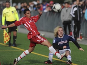 Burnaby Central's Alan Camacho Soto (left) and Cole Keffer of Sutherland met Saturday on the turf at the Burnaby Lake Sports Complex during the B.C. senior boys Triple A soccer championship final. Sutherland scored a 2-1 double-overtime victory to win the school's first varsity boys soccer crown since 1986. (Jason Payne, PNG)