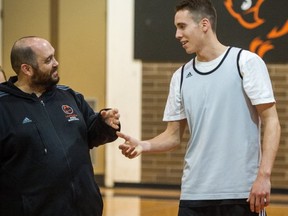 Langara College Falcons' point guard Brody Greig talks shop with head coach Paul Eberhardt as the CCAA 2013 Final Four finalists opened practice Wednesday evening in Vancouver. (Ric Ernst, PNG photo)