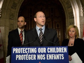 Justice Minister Peter MacKay, flanked by Public Safety Minister Steven Blaney and Lianna McDonald of the Canadian Centre for Child Protection, announces Criminal Code changes to address cyber-crimes. (THE CANADIAN PRESS)