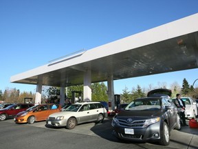 Drivers get in line with their vehicles to fill them up as well as gas containers in Bellingham, Wash. High Canadian taxes are driving people south of the border for cheap gas. (Kim Stallknecht/PNG FILES)