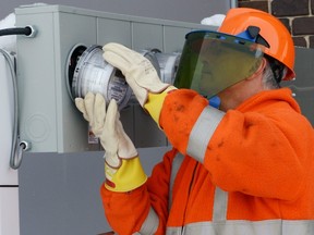Smart meters are being installed all over the place. Here, Bob Hunchak with SaskPower installs a new residential advanced meter at a SaskPower testing site in Regina in March 2013. (POSTMEDIA NEWS FILES)