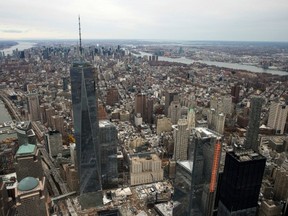 The 533-metre-tall One World Trade Center, towering over the wedge-shaped entrance to the National Sept. 11 Museum and the square outlines of the memorial waterfalls in New York, is now the tallest building in the U.S. (ASSOCIATED PRESS FILES)