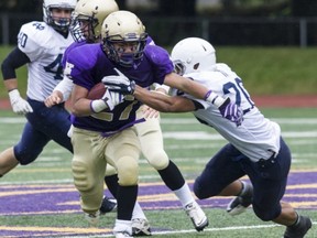 Vancouver College running back Clyde Casip (left) is slowed by Notre Dame's Aldrich Berrios on Friday in the Archbishops' Trophy game at O'Hagan Field. (Steve Bosch, PNG photo)
