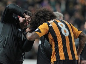 Hull City's English midfielder Tom Huddlestone (R) celebrates scoring their fourth goal and has his hair cut after pledging not to cut it until he scored, during the English Premier League football match between Hull City and Fulham at the KC Stadium in Hull, north-east England on December 28, 2013. Hull won the game 6-0.
(LINDSEY PARNABY/AFP/Getty Images)