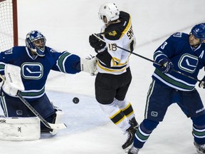 DECEMBER14 2013. Vancouver Canucks  Roberto Luongo makes a save against  Boston Bruins Reilly Smith  in NHL action at Rogers Arena in Vancouver, B.C.  , on December 14, 2013.  (Steve Bosch  /  PNG staff photo)