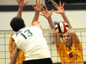 Kelowna Owls' Sam Taylor-Parks (right, 6) got a block on Earl Marriott's Jacob Smith (13) but Smith and the rest of Mariners went on to top the host Owls 3-1 in the B.C. senior boys Triple A volleyball championship final on Saturday. Smith was later picked the tournament's Most Outstanding Player. (Photo -- Lorne White, Kelowna Daily Courier)