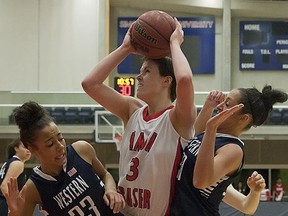 Simon Fraser's Erin Chambers battles in the paint with Marcel Pounds (L) and Katie Colard of Western Washington on Saturday night atop Burnaby Mountain in SFU's GNAC opener. (Ron Hole, SFU athletics)
