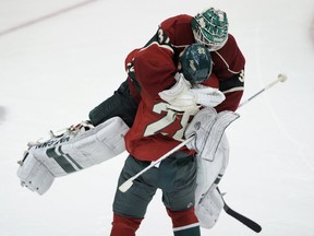 Josh Harding and Zenon Konopka celebrate the Minnesota Wild's 3-2 shootout win over the Vancouver Canucks on Dec. 17, 2013 in St. Paul, Minn. Getty Images photo.