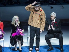 Gino Odjick, flanked by former Canucks general manager Pat Quinn and members of Pavel Bure's family, acknowledges his ovation on Nov. 2 at Rogers Arena.