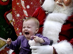 This tot is not so pleased to be sitting on Santa's knee.