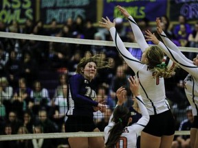 South Delta Sun Devils' Christine Howlett (left) delivers a kill at the net against Surrey's Earl Marriott Mariners before a packed house in the final of the B.C. Quad A senior girls volleyball championships on Saturday at Penticton Secondary. (Paul Yates, Vancouver Sports Pictures)