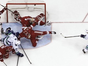 The Vancouver Canucks' Daniel Sedin misses an open net against the Phoenix Coyotes on Jan. 16, 2014. AP photo.