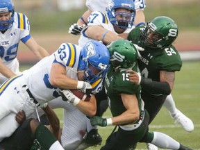 Brandon Deschamps (33) and the UBC Thunderbirds football team were one of 16 varsity sports programs to survive the cut. (PNG photo)