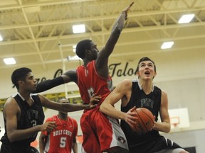 Graham Smith (right) of the Pitt Meadows Marauders does his stuff in the paint against Holy Cross in the final of the Gleneagle Talons Invite just prior to Christmas. (PNG photo)