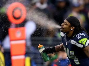 Marshawn Lynch sprays water in Seattle on Jan. 11, 2014. Getty Images photo.