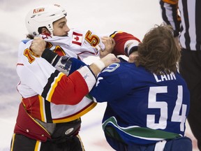 The Vancouver Canucks' Kellan Lain and the Calgary Flames' Kevin Westgarth drop the gloves at Rogers Arena on Jan. 18, 2014. PNG photo by Gerry Kahrmann.