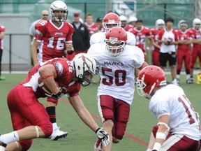 WJ Mouat defensive end Sheriden Lawley (50), pictured during his Grade 11 season on 2011, will join the NCAA 1 UConn Huskies next season. (PNG photo)