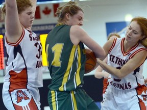 With St. Thomas Aquinas Fighting Saints’ Angela Clarke (left) defending, teammate Claire Mockler attempts a steal from the Windsor Dukes during a game at the recent Telus Basketball Classic at UBC. (Photo submitted)