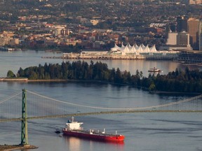 Oil tanker guided by tugs sails under the Lions Gate Bridge in May 2012. Oil sales help pay for government programs, say authors. People need to know what programs they’ll lose without oil exports and new pipelines, they say.­ (THE CANADIAN PRESS FILES)