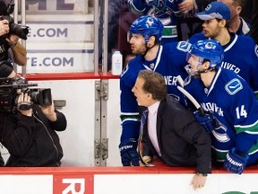 Vancouver Canucks head coach John Tortorella yells at the Calgary Flames bench holding players and head coach Bob Hartley in the first period of game at Rogers Arena on Jan. 18. (Gerry Kahrmann/PNG FILES)