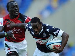 Carlin Isles of the United States fends off the defence to score a try during the Gold Coast Sevens round one match between Kenya and the United States at Skilled Stadium on October 12, 2013 on the Gold Coast, Australia. (Photo by Matt Roberts/Getty Images)