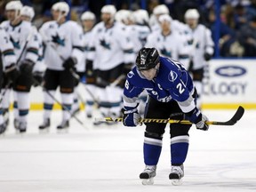 TAMPA, FL - JANUARY 18:  Martin St. Louis #26 of the Tampa Bay Lightning reacts as members of the San Jose Sharks celebrate a win at the Tampa Bay Times Forum on January 18, 2014 in Tampa, Florida. (Photo by Mike Carlson/Getty Images)