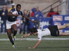 The United States' Carlin Isles carries the ball past Uruguay's Francisco Lopez during the US Rugby Sevens tournament in Las Vegas, Nevada, January 26, 2014.  (Photo Isaac Brekken/AFP/Getty Images)