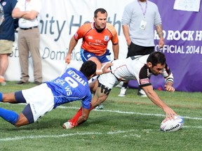 Philip Mack #9 of Canada scores a try against Vavao Afemai #9 of Samoa during the USA Sevens Rugby tournament at Sam Boyd Stadium on January 26, 2014 in Las Vegas, Nevada. Canada won 22-19. (Photo by Ethan Miller/Getty Images