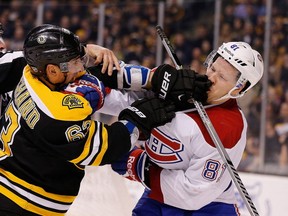 Brad Marchand (63) of the Bruins gets up close and personal with Lars Eller of the Canadiens.  (Photo by Jim Rogash/Getty Images)