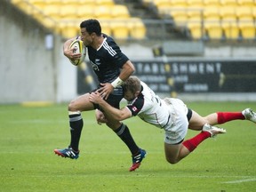 Sherwin Stowers (L) of New Zealand is tackled by Conor Trainor of Canada in their Cup Quarter Final match during round 5 of the IRB Rugby Sevens in Wellington on February 8, 2014. (Photo: Marty Melville/AFP/Getty Images)