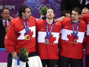 Roberto Luongo, Duncan Keith, Dan Hamhuis. Table-toppers in more ways than one, it turns out. (Photo by Bruce Bennett/Getty Images)