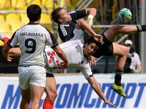 New Zealand's Tim Mikkelson (C) vies with Canada's Sean Duke (R) during their group stage of the Rugby World Cup Sevens 2013 match in the Luzhniki Stadium in Moscow on June 28, 2013. AFP PHOTO/KIRILL KUDRYAVTSEVKIRILL KUDRYAVTSEV/AFP/Getty Images