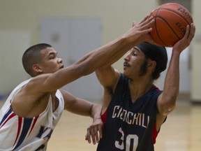 Ashton Kendall (left) of the Yale Lions defends Gary Minhas of the No. 2-ranked Sir Winston Churchill Bulldogs of Vancouver during semifinal action at the recent Bill Kushnir Memorial tournament Jan. 24 in Ladner. (PNG photo)