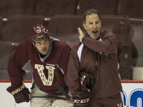 Forward Tom Sestito and coach John Tortorella (right) during Vancouver Canucks practice at Rogers Arena in Vancouver, BC, February 24, 2014.   (Arlen Redekop / PNG staff photo)