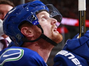 His teammates look up to the ailing Henrik Sedin, but you have to wonder if the Vancouver Canucks captain should be sitting instead of risking further injury to his ribs. (Getty Images via National Hockey League).