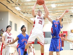 Kieran Janes (white) and the rest of Burnaby's St. Thomas More Knights continue to hold down the No. 2 spot in the B.C. Triple A basketball rankings. (Jason Lang, The Burnaby Now)