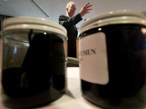 Raw and diluted bitumen are displayed in jars as newspaper publisher David Black speaks in August 2012 about his proposal to build a crude-oil refinery in Kitimat to refine Alberta oilsands crude shipped to the B.C. coast through the proposed Enbridge Northern Gateway Pipeline. Green MLA Andrew Weaver supports the plan as a better option than shipping crude in tankers. ( THE CANADIAN PRESS FILES)