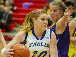 MEI Eagles' Taylor Claggett drives past Anita Cremer of Surrey's Elgin Park Orcas during Fraser Valley 3A opening round playoff action Monday night in Abbotsford. (Ric Ernst, PNG)