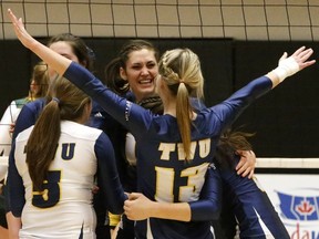 The face of Trinity Western's Alicia Perrin tells the story Friday as the host Spartans, including Kristen Moncks (5) and Chelsea Wand (13), beat the Regina Cougars 3-0 at the Langley Events Centre to sweep its best-of-three opening-round Canada West women's volleyball playoff series. (Scott Stewart, Trinity Western athletics)