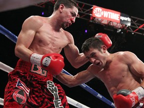 Unified junior welterweight champion Danny Garcia (left) exchanges punches with challenger Mauricio Herrera. Photo: Tom Casino / Showtime