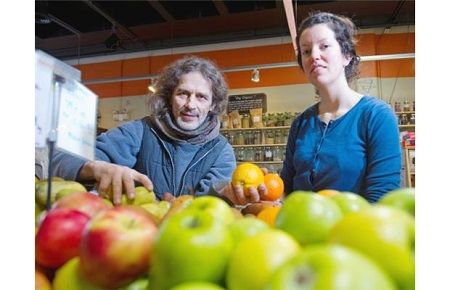 At the Eternal Abundance Grocery and Cafe in Vancouver, produce manager Jeremy Blaine, left, and store manager Alexandra Brigham display fruit.
