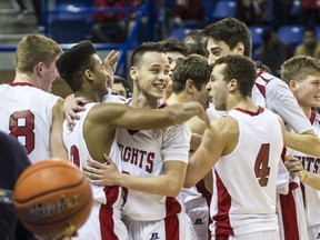 St. Thomas More Knights celebrate win over Charles Hays Rainmakers in  AAA B.C. High School Boys Championship game at Langley Events Centre in Langley, B.C., on March 15, 2014.   (Steve Bosch  /  PNG staff photo)
