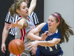 Alli Buck (left) of the Holy Cross Crusaders, gets a body on Fleetwood Park's Gabrille Musico during Telus BC girls Triple A basketball quarterfinals on Thursday at the LEC. (Ric Ernst, PNG photo)