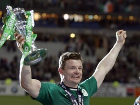 Ireland's Brian O'Driscoll celebrates with the trophy after defeating France and winning the Six Nations Rugby Union tournament at the stade de France stadium, in Saint Denis, outside Paris, Saturday, March 15, 2014. (AP Photo/Christophe Ena)