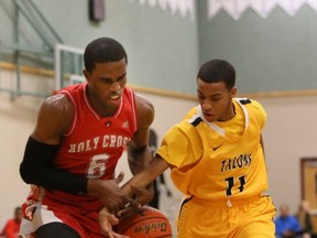 Doing it on defence, Gleneagle Talons' guard Brenden Bailey (right) looks to strip Holy Cross Crusaders' Henry Maduabueke of the ball during first-half action in the Terry Fox Legal Beagle championship final on Jan. 11. The two teams are positioned for another possible meeting, this time in the Final Four round at the upcoming B.C. Quad A championships. (Kim Stallknecht, PNG photo)