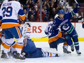 Jordan Schroeder celebrates teammate Chris Higgins' goal against the New York Islanders on Monday night.